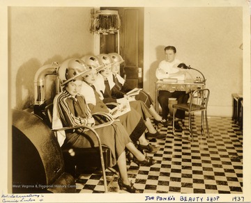 Four young women posing with hair dryers in Joe Ponka's Beauty Shop, Morgantown.  Roberta Armstrong is second from left; Connie Linton is fourth from left.