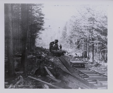 Starting up Shavers Fork (Shay in woods at end of tracks); Walter Good 'Bluejay' Tumblin on flatcar (maybe not Walter Good - maybe Barney Showalter); D.D. Brown Collection.