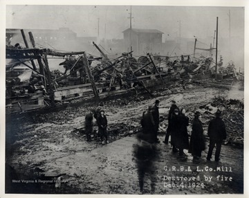 People standing by the remains of the Cherry River Boom and Lumber Co.