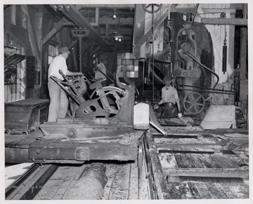 Men working with mill equipment.  L to R  1. Setter, William Simmons (sawed the last log at Cass July 1, 1960)  2. Oliver Tyson  3. unknown.