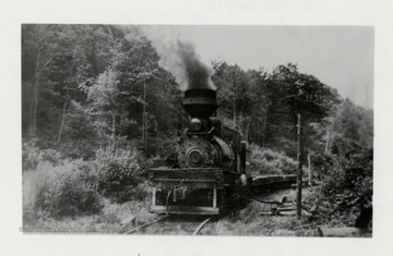 Shay No. 4 engine traveling on tracks.  