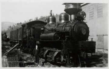 Portrait of Ivan Clarkson standing next to train engine. Sunday afternoon; Ivan Clarkson Collection.