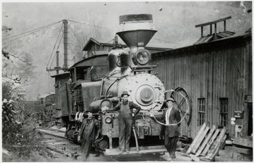 Front view of Shay #1 train engine and 3 men in front of it.  One man in cab.  