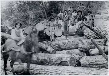 Loggers standing on log pile.  Mill located at Glenray - 1 mile west of Alderson, W.Va.