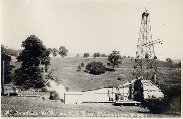 Oil rig and derrick in the countryside.