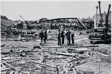 Men inspect the ruins of the Bridgeport Station after a tornado.