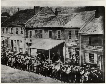 Men line up to volunteer across from the Court House, at Carrico Corner - High and Walnut Street, Morgantown, W. Va.