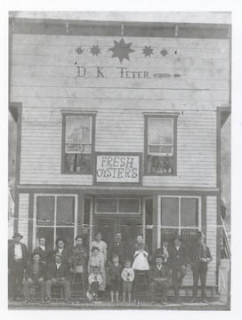 D.K. Teter's General Store offering fresh oysters.  Group assembled for portrait in front of store.