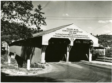The historic old covered bridge at Philippi, completed in 1852, has been in continuous use for 109 years and still serves to carry the heavy traffic on U. S. Highway 250 across the Tygarts Valley River. Veteran of the Civil War, it was the first bridge captured, and was used throughout the war by troops of both armies.   It has had its own centennial celebration, and now will be a center of attraction in the observance of the centennial of the first land battle of the Civil War. See West Virginia Collection Pamphlet 6610 and Boyd Stutler's 'WV in the Civil War.'