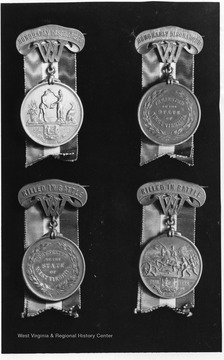 The first two classes of the West Virginia Civil War medal, front and back. For the Honorably Discharged and for those killed in battle, front and back.  See West Virginia Collection pamphlet 6610 and Boyd Stutler's 'WV in the Civil War.'