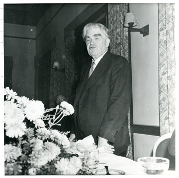 John L. Lewis standing behind a table during a Consolidation Coal Co. Inspection Trip.