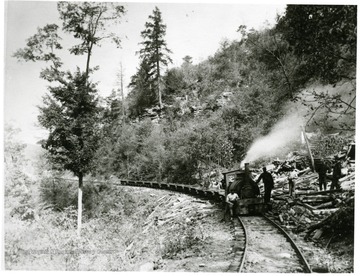 Men standing next to the main line locomotive at Fire Creek.