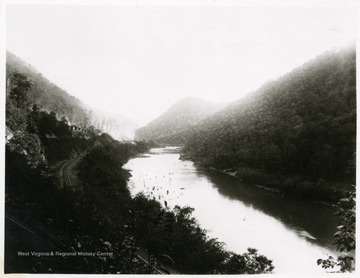 View of the river, railroad, and houses at Caperton, W. Va.<br />