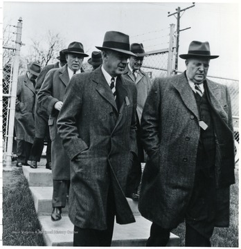 Coal officials walking down sidewalk stairs during a Consolidation Coal Co. Inspection trip.