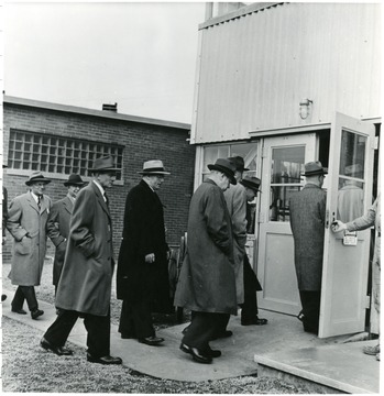 Coal officials entering building during a Consolidation Coal Co. Inspection trip.