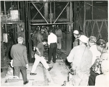 Men leaving an elevator after a mine accident in Monongalia County.