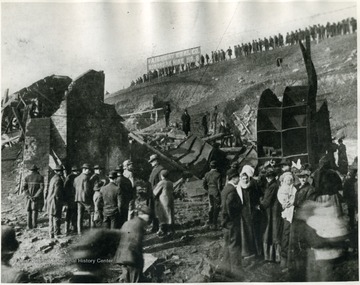 Shows the scene about the mouth of No. 8 Monongah Mine, Marion County, W. Va., where the fan house and other buildings were completely demolished by the force of the explosion and where Engineer Byce was killed. The photograph was taken just as bodies of the victims were being brought out of the mine. 