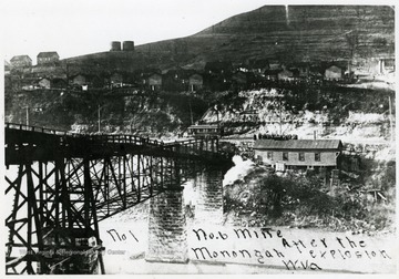 Tracks and trestle leading into mine no. 6 after the Monongah disaster.  People gathered below houses on hill.