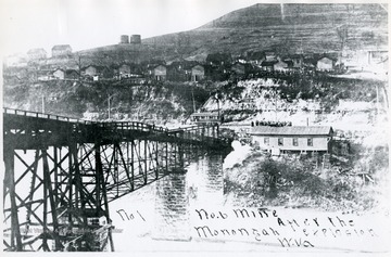 Tracks and trestle leading into mine no. 6 after the Monongah disaster.  People gathered on the hillside above.