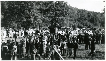 Crowds watch groups of men rehearsing mine safety procedures. 