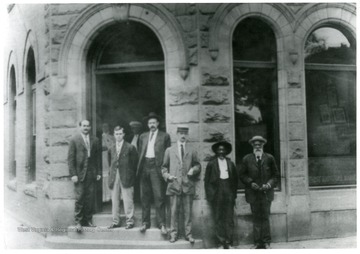 Officers in front of Alderson National Bank 'Left to right: James H. George, Cashier, H. B. Rowe, Asst. Cashier, L. E. Johnson, President and Dr. J. H. A. Miller Dentist.'
