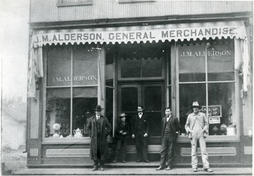 'J.M. Alderson(fourth from the left) and others in front of his store. (Credit; J.M. Alderson)'