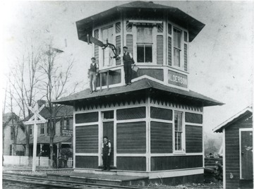 Telegraph tower located in Alderson W. Va. Operators: O.D. Massey, in door; J Abe Bright, on left roof; J.G. Houchins, on right roof. 