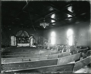 Interior of Greenbrier Baptist Church in Alderson. Interior containing pews and floral garlands and floral arches.