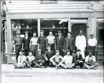 Unidentified men in front of Hamlett's Electrical Shop, at the south end of bridge on Monroe Street. Thought to be Virginia Western Power Co. crew who installed their system in Alderson, West Virginia.