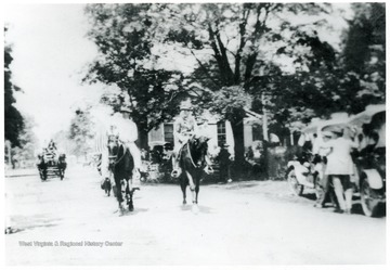 'A. C. Crotty 'left' and Merchant Jesse Keadle as Uncle Sam lead off Alderson, W. Va.'s 4th of July celebration parade on Railroad Avenue.'
