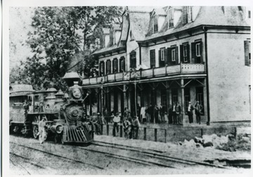 'C&O Train, The Huntington to Richmond Express at the breakfast shop by the Alderson House Hotel on the morning of April (?) 1885. The locomotive is No. 32, and the engineer is ? Noel.'
