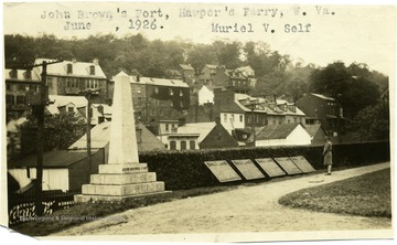 A woman reads the historic markers next to a monument to John Brown's Fort in Harpers Ferry, W. Va. 'Muriel V. Self."