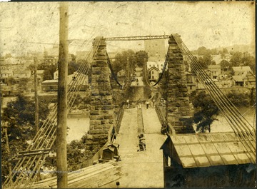 Workmen can be seen standing on bridge. 