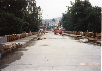 Nearly completed South Park bridge. Equipment and one worker can be seen. Also, scrap material can be seen. 