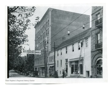 'Before 1927, High and Fayette Street. Strand Theater on right burned down on October 14, 1927.' Sign across the street says 'Window Display of Scranton Schools, Jolliffes Store'.