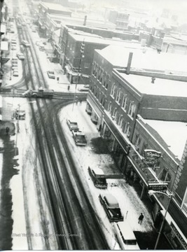 On a snowy winter day, a view of Walnut and High Streets in Morgantown, West Virginia. Odd Fellows is on the right corner. 