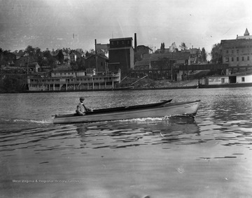 A riverboat is visible along the shore near Walnut Street as a dapperly attired man cruises in the "Nancy".