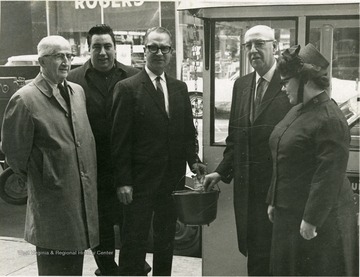 People standing at the Salvation Army Kettle on High Street. Some of the people in the picture include: 'J.A. Dickey, Omar G. McKinny, Robert Bowlby.'