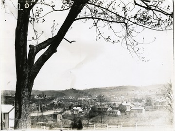 'Cameraman was near the DeMain Building on west side of South High Street near the bridge. Showing the Judge Dille property far in the background. The house at the end of the bridge was formerly the property of the late Henry L. Cox, father of Judge Cox. This house was moved about 300 yards up the hill and is now standing in good condition. Note the old Arnett hotel near the west end of the bridge. Shows Mechanical Hall by R. R. and J. W. Wiles house on Highland Avenue. Must have been about 1897.' 