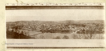 'View of Morgantown from Keck's Hill across the River. Note the Suspension Bridge as well as the old covered Durbana Bridge across the Deckers Creek. Taken in late  eighties. Property of Jas. R. Moreland.'
