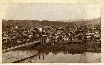 'Morgantown from across the Monongahela River. Sometime in the late eighties. Note this is the suspension bridge the Confederates partly burned during the Jones-Imboden raid in the Civil War. Property of Jas. R. Moreland.'