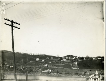 'View of the West Side taken from West Virginia University. Shows the West Side Brickyard before the railroad was built over there. Also of view of Keck's Hill with the orchard on it.'