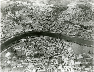 An aerial view of Morgantown. The Monongahela River is running through the center. West Virginia University campus and Mountaineer Field on the left right above the river.