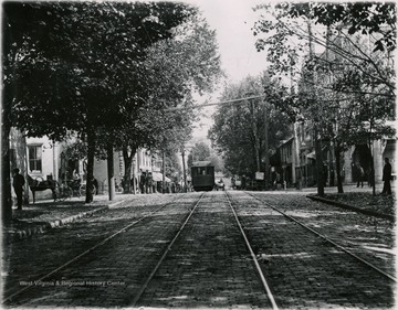 Street car on corner of High Street and Pleasant Street. Moore and Parriott's drug store on the right side corner.