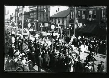 Men riding in a car with flags and a washtub in the Armistice Day Parade in Morgantown, West Virginia.