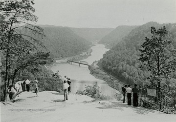 People looking at the aerial view of Hawk's Nest Rock and New River Canyon.