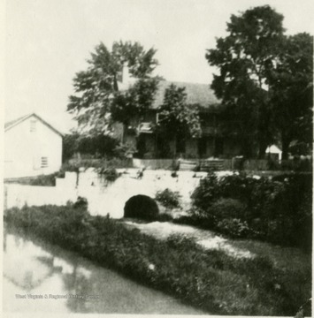 Old C&amp;O Canal, and in the background the old Knode home, practically destroyed by the flood of 1936.