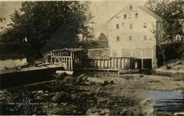 A view of Jackson's Mill with two people below the building.