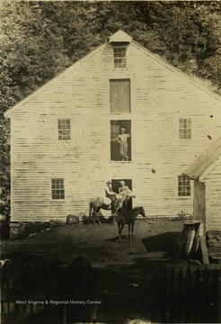 'The ravages of time. The mill in 1886 with Joseph Clifton, owner, standing in the door.'