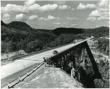 The Charlton Memorial Bridge towers 246 feet over the Bluestone Gorge.  This photo was copyrighted in 1955 by Harlow Warren of Beckley.  